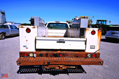 Ford F-450 SD XL utility truck rear view showing Monroe equipment bed and rusted bumper area.