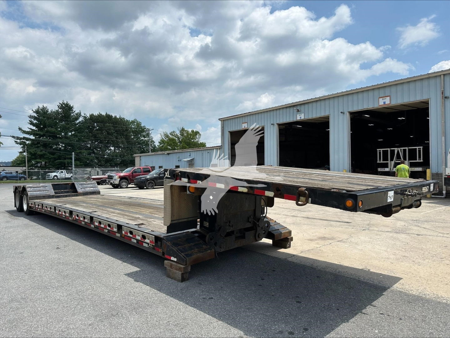 Double Drop Expandable trailer in a yard showing two flatbeds extended and hydraulic neck area, XL Specialized XL80Mfga.