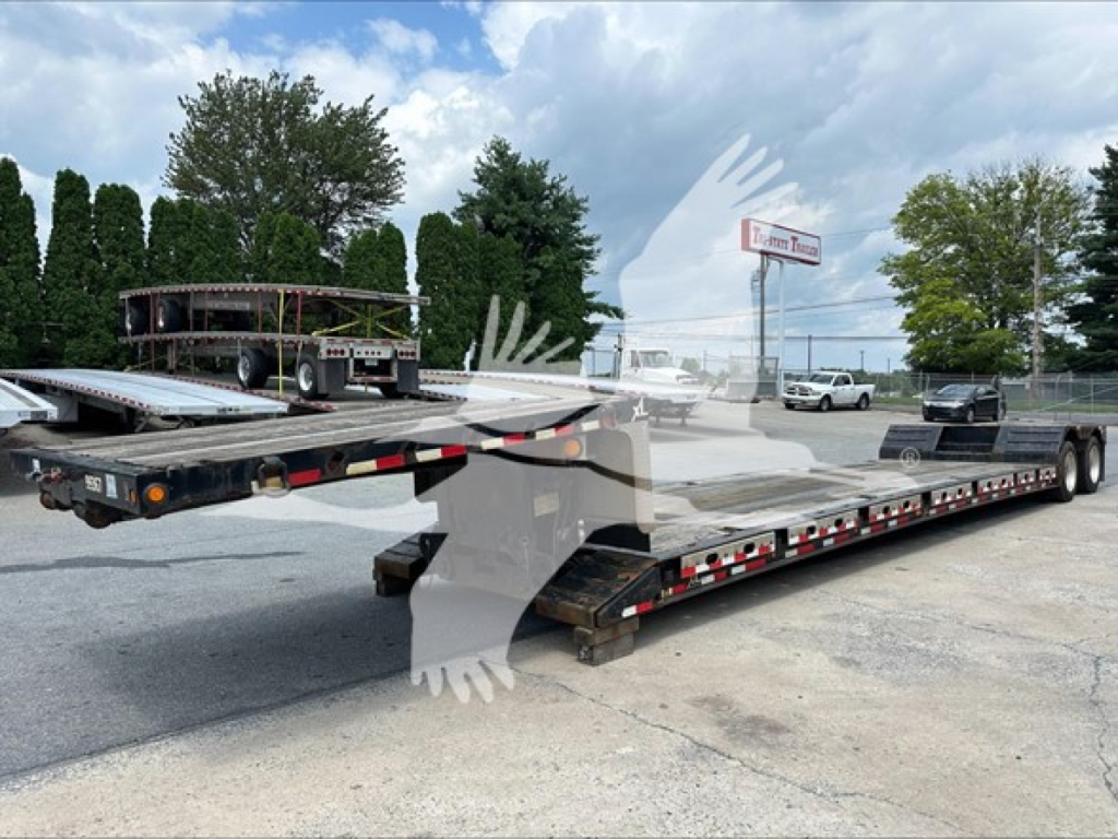 Trailer showing a low-profile XL80MFGA double-drop expandable trailer with extended flat deck and dual rear axles.