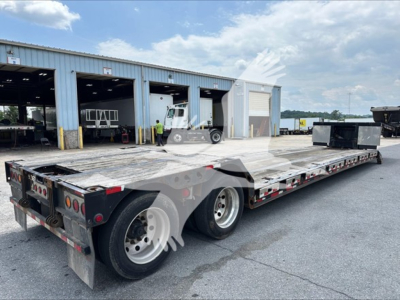 Trailer showing a low-profile flatbed with dual rear axles and gooseneck neck, XL Specialized XL80MFGA model, aluminum deck, in-service with stock 7417.