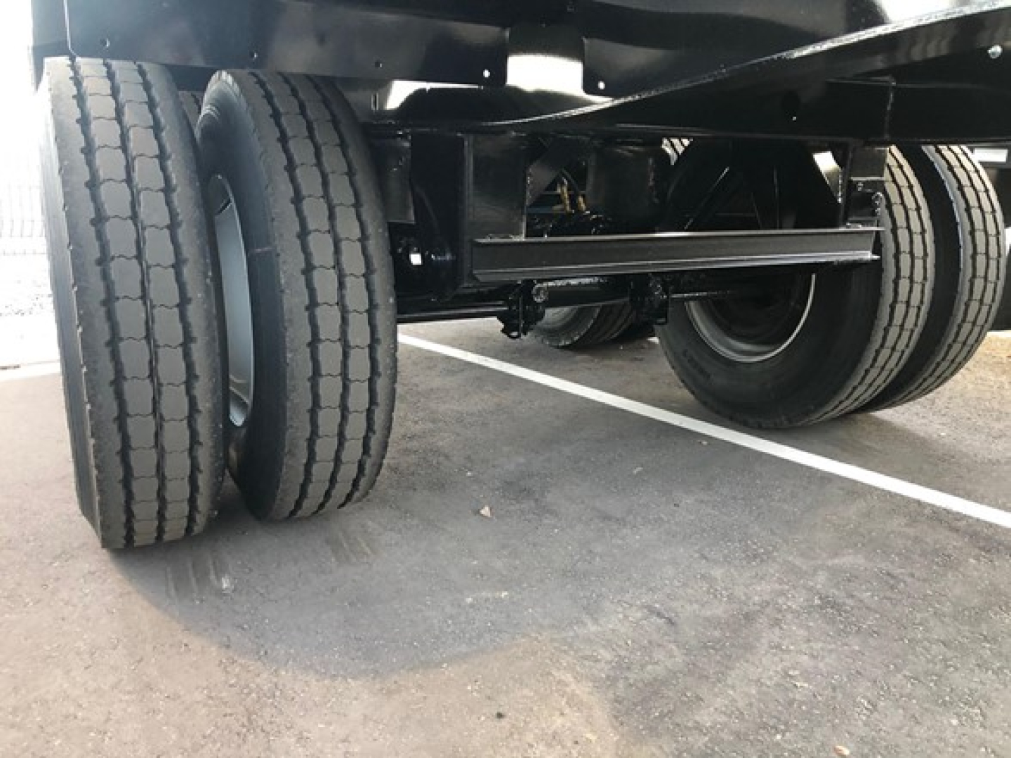 Jet Air Ride side dump trailer showing dual rear tires and undercarriage components.
