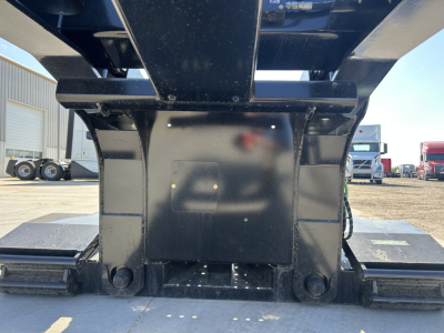 Front view of a Load King trailer lowboy hitch area showing heavy steel center framing and pin supports.