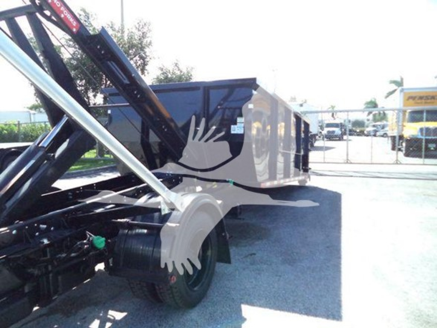 Truck side view showing a Black hardware trailer with hydraulic arm and wheel, part of a new 2023 Chevrolet Silverado 6500Hd listing.
