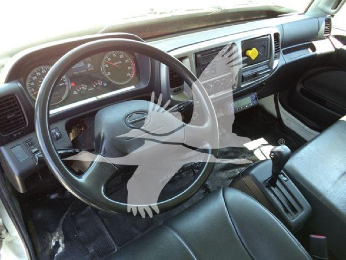 Cab interior of 2019 Hino 268a refrigerated truck showing steering wheel, dashboard gauges, gear shifter, and center console.