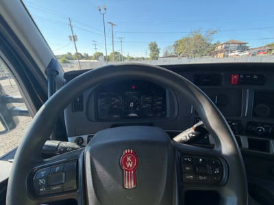 Kenworth T680 steering wheel and dashboard interior view with instrument cluster and steering controls.