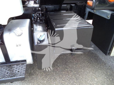 Fuel tank and auxiliary container near cab area of 2019 Freightliner Business Class M2 106 rollback truck showing fuel tank and battery/auxiliary box.