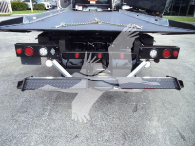 Rear view of a Freightliner Business Class M2 106 rollback bed showing bumper lights and rear equipment.