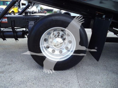 Freightliner Business Class M2 106 rear truck wheel and suspension, dual rear axle area, wheel with shiny silver rim.
