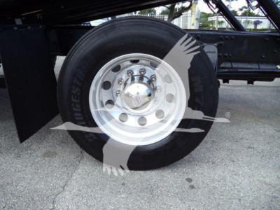 Wheel and tire assembly of Freightliner truck showing steel rim and tire with circular hub and lug nuts.