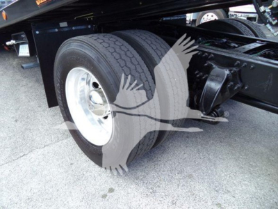 Freightliner M2 106 drive axle with dual rear tires and suspension components visible in the truck chassis.