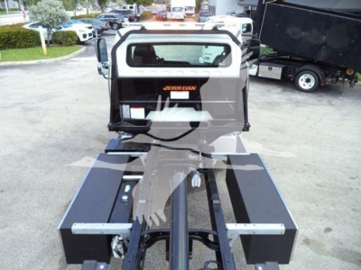 Freightliner roll back truck rear with Jerr-Dan carrier, chassis, and hydraulic components visible.