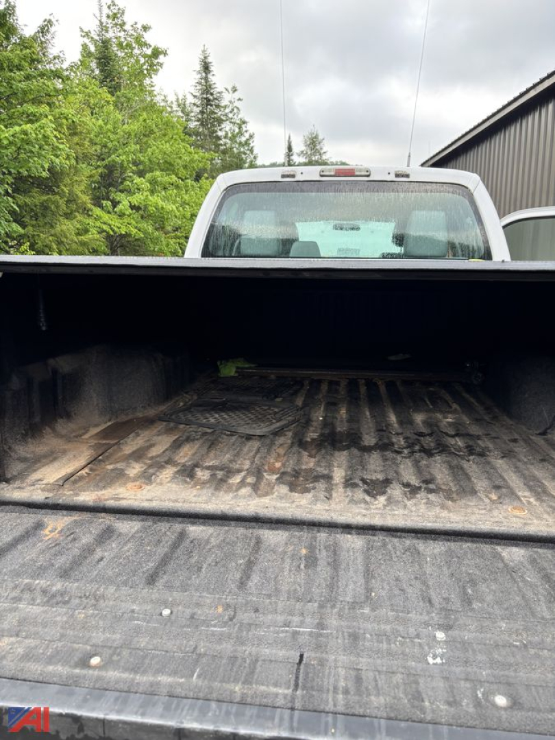 Truck bed of a 2016 Ford F-250 Super Duty crew cab pickup with tailgate down showing cargo bed with dirt and wear.