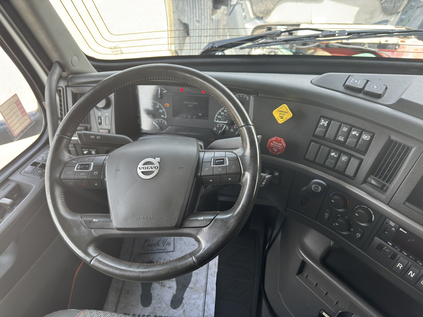 Volvo VNL dashboard with steering wheel and control panels visible