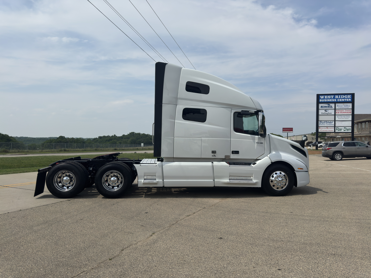 Volvo VNL64T760 tractor in side profile view showing sleeper cab, chassis, and rear axles.
