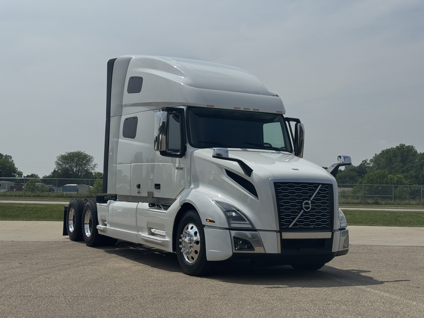 Volvo VNL64T760 sleeper tractor in silver showing front grille, cab, and dual rear axles; no visible fluids or labels readable.