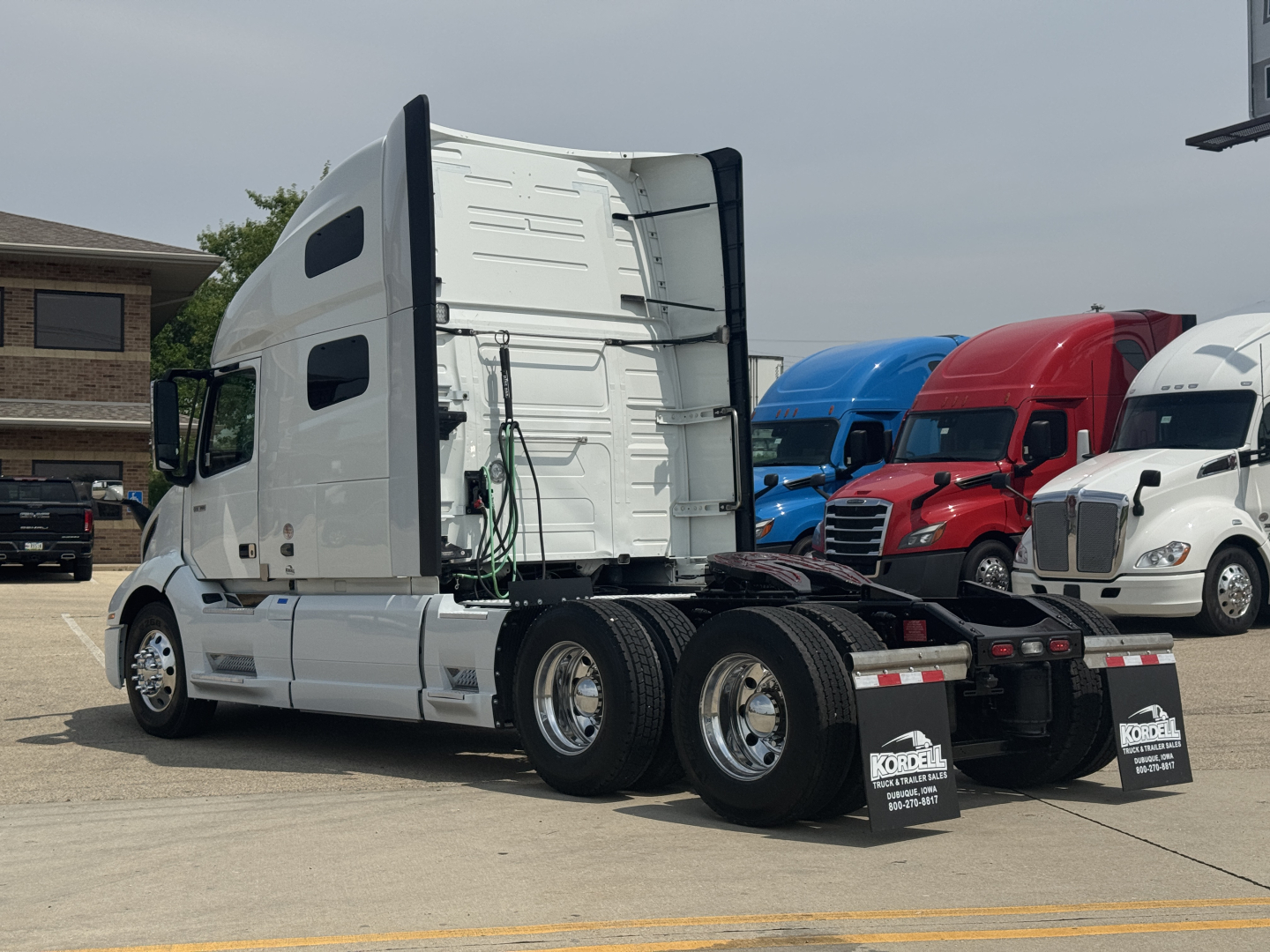 Volvo VNL64T760 truck cab and chassis side view showing sleeper gap and rear dual axles.