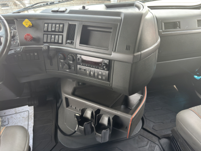 Volvo VNL64T760 cab interior showing dashboard controls with multiple switches, vents, and cup holders