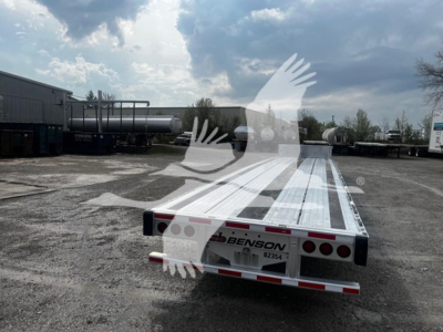 Trailer rear view of a Transcraft aluminum drop deck showing Benson trailer company plate and tail lights.