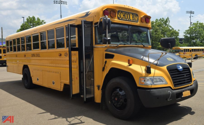 Blue Bird Vision school bus in-service showing front and left side with school bus signage and doors open.