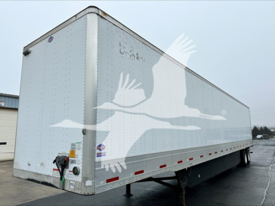 Trailer side showing Utility 4000D-X box trailer with VIN tag area and hydraulic jack legs visible.