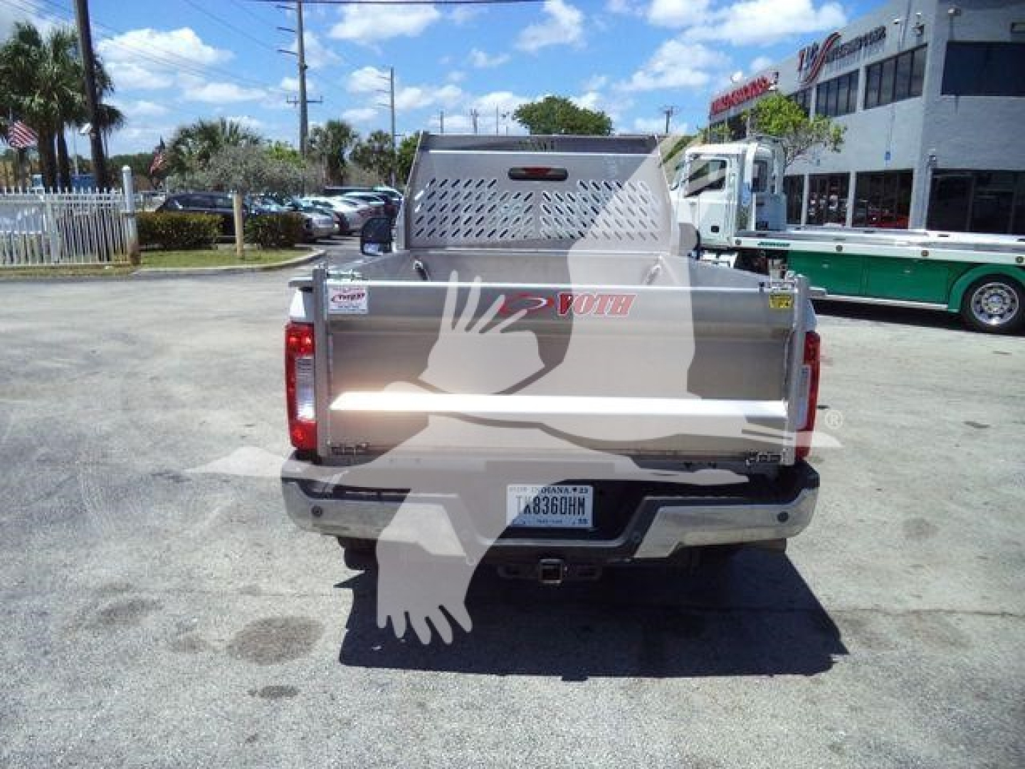 Volvo 8 ft truck bed shown from rear with aluminum utility bed and perforated toolbox, tailgate, and rear bumper.
