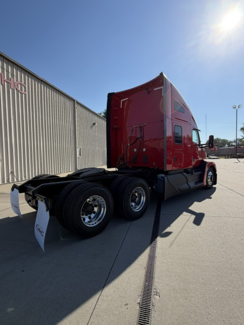 Kenworth T680 tractor shown from rear three-quarter view, red cab, dual rear axle, fifth wheel and chassis visible.