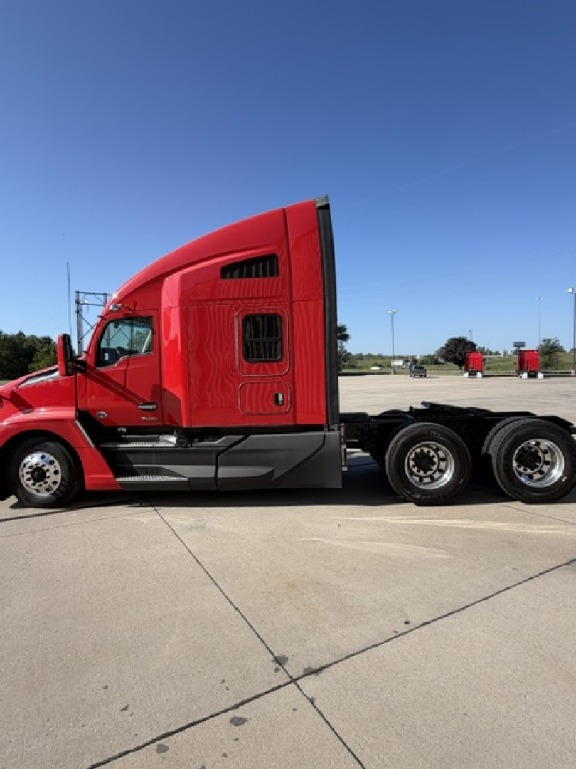 Kenworth T680 tractor cab side view showing red exterior and sleeper compartment
