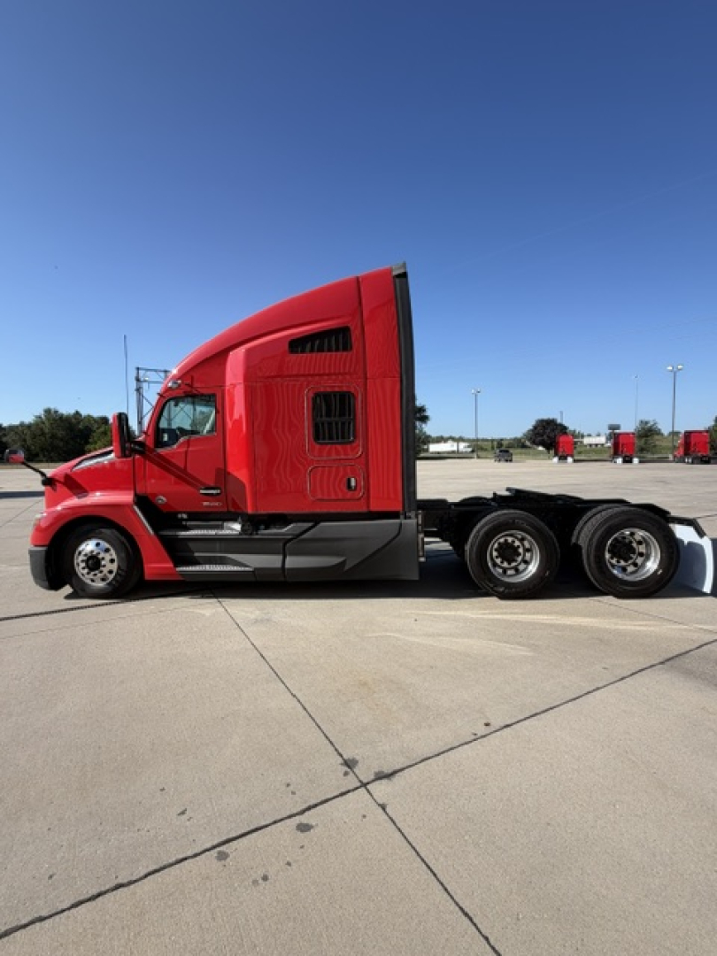 Kenworth T680 tractor-trailer side view showing sleeper cab, chrome fuel tanks, and triple rear axles.