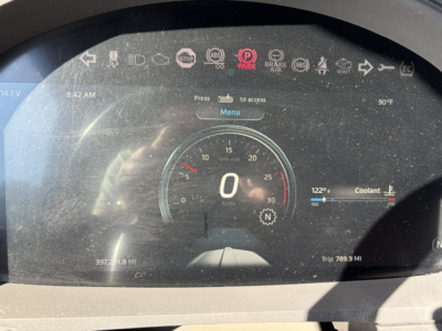 Kenworth T680 gauge cluster/driver dashboard showing a zero speedometer and various indicator icons.
