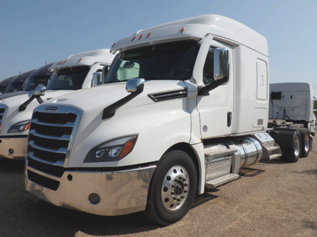 Truck engine bay area not visible; front left side of white Freightliner Cascadia 126 tractor.
