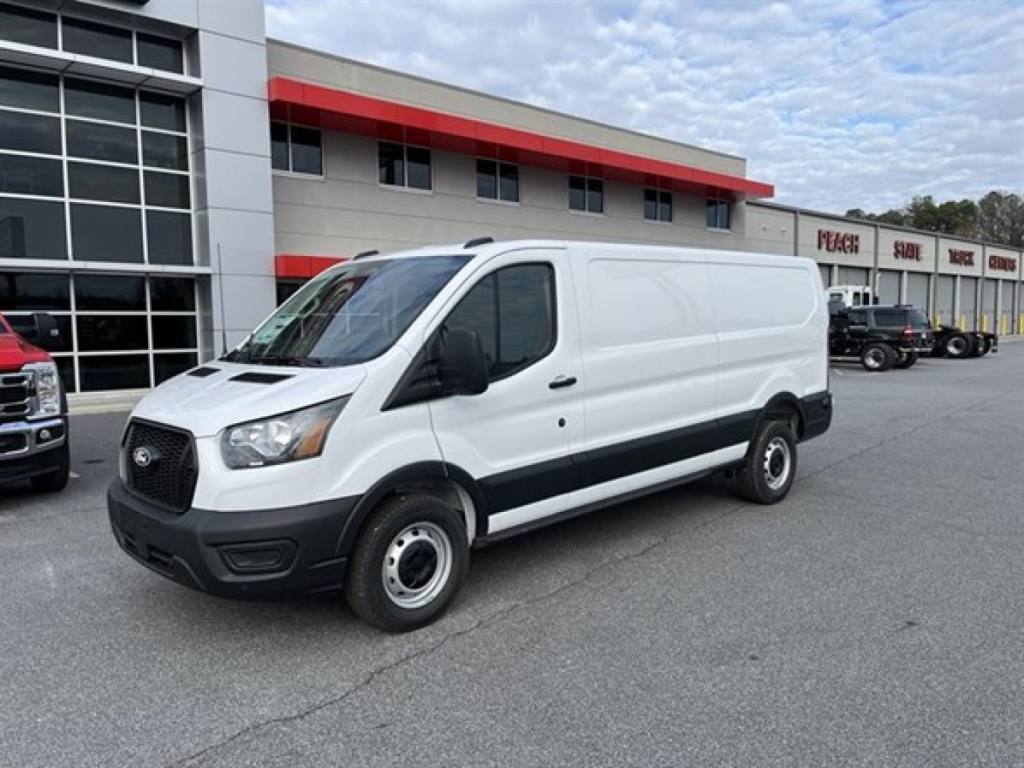 Ford Transit cargo van in white, front-left view showing cargo van exterior with black plastic bumper and wheels.