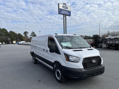 Ford Transit cargo van in dealership lot showing front-right view with open cargo area, grille, and Ford badge.