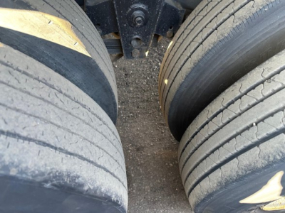 Trailer wheels and suspension view for 2012 Direct Steel flatbed showing dual axles and tire treads.