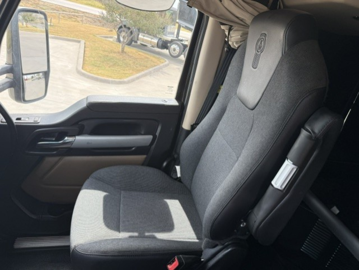 Kenworth T680 interior driver seat and door panel.