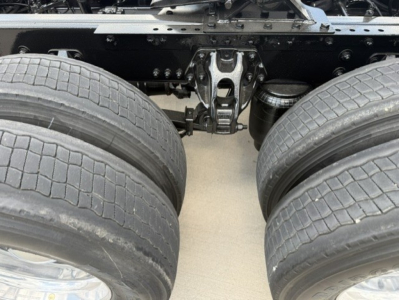 Kenworth truck undercarriage showing dual rear axles and suspension components.