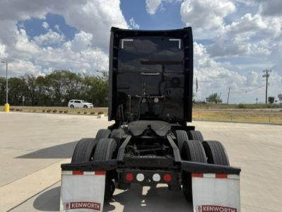 Kenworth T680 rear view showing fifth wheel area and dual rear axles with Kenworth mud flaps.