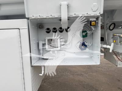 Bottom Petro Tank trough showing control valves, hoses, and gauge fittings with white protective cover and green/blue valves.