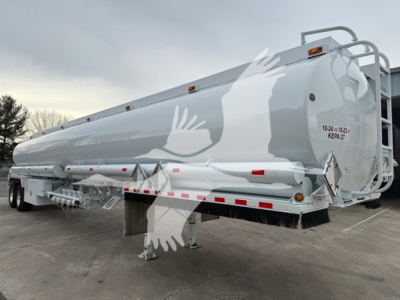 Trough bottom petro tanker trailer showing white and gray exterior with safety decals and rear access ladder.