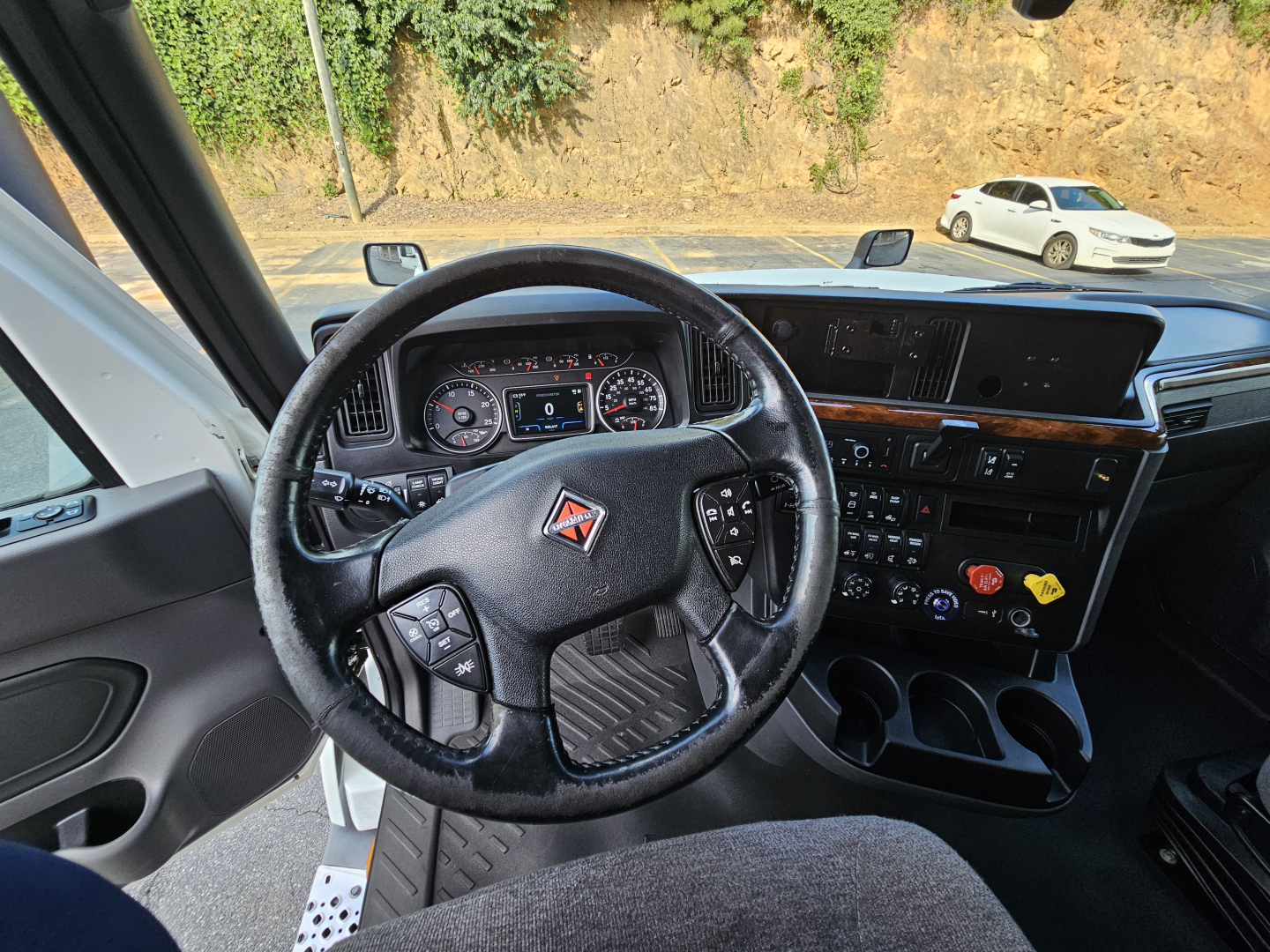 Interior of 2021 International LT625 truck showing steering wheel and dashboard with multiple controls and center console.