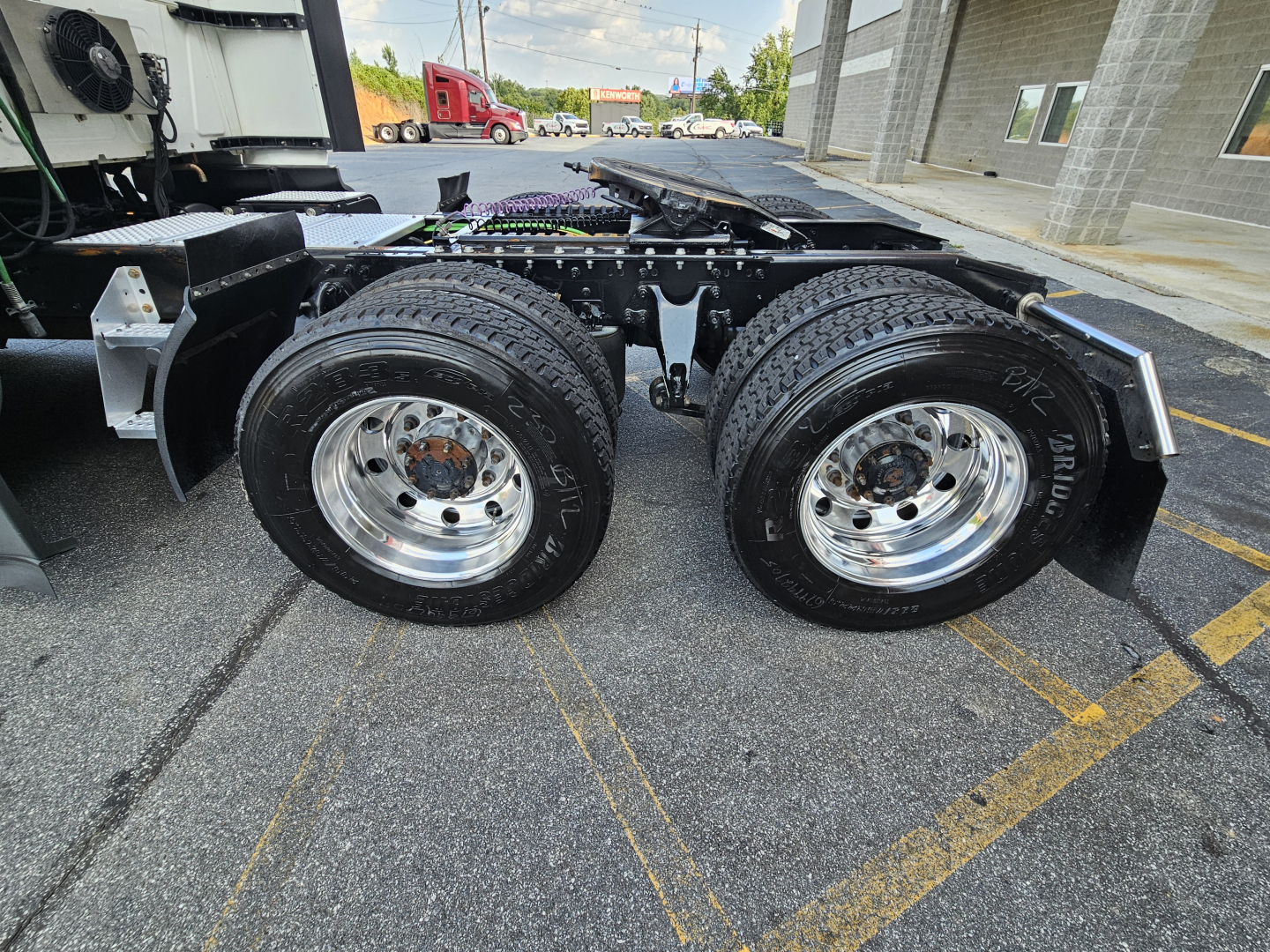 Rear axle view of a used 2021 International LT625 truck showing dual rear wheels and chrome rims.