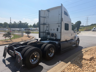 Tractor unit cab and rear show 6x4 rear wheels with fuel tanks and standard sleeper cab; no legible text visible on the cab side from this angle.