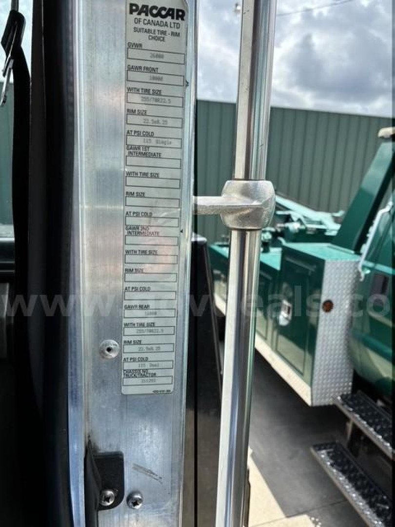 Truck door jamb label showing tire, axle, and VIN information on a Kenworth T3 Series truck.