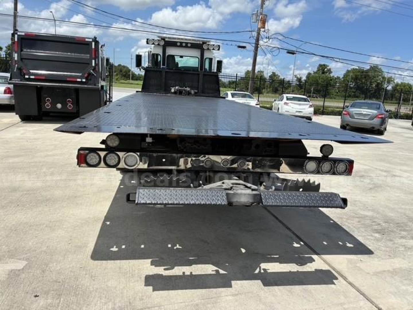 Kenworth tow truck bed rear view showing flatbed and rear lighting, model visible as 2018 T3 series.