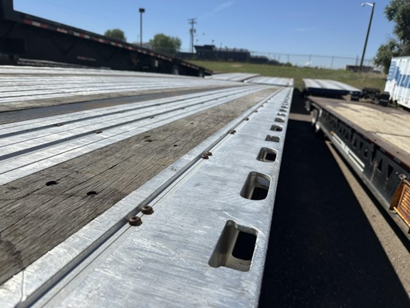 Flatbed trailer deck with metal surface and tie-down slots; part of a 2020 Fontaine 48' spread air combo flatbed listing.