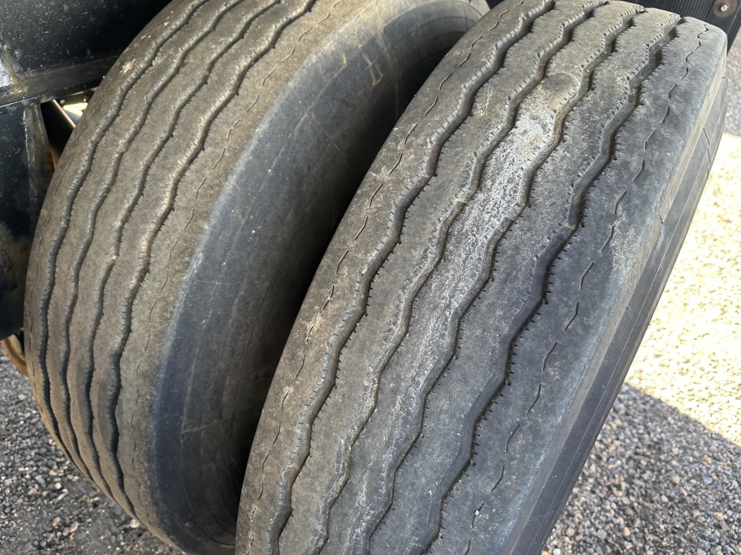 Dual rear tires on a 2020 Fontaine 48' spread air combo flatbed trailer showing worn tread and sidewall details.