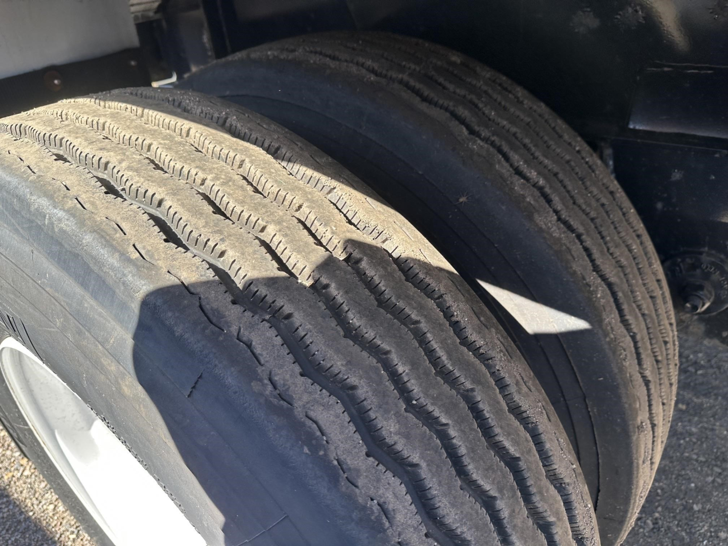 Trailer wheel close-up showing dual tires with tread and sidewall; part of Fontaine 48' spread air combo flatbed trailer.