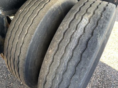 Dual rear tires on a 2020 Fontaine 48' spread air combo flatbed trailer showing worn tread and sidewall details.