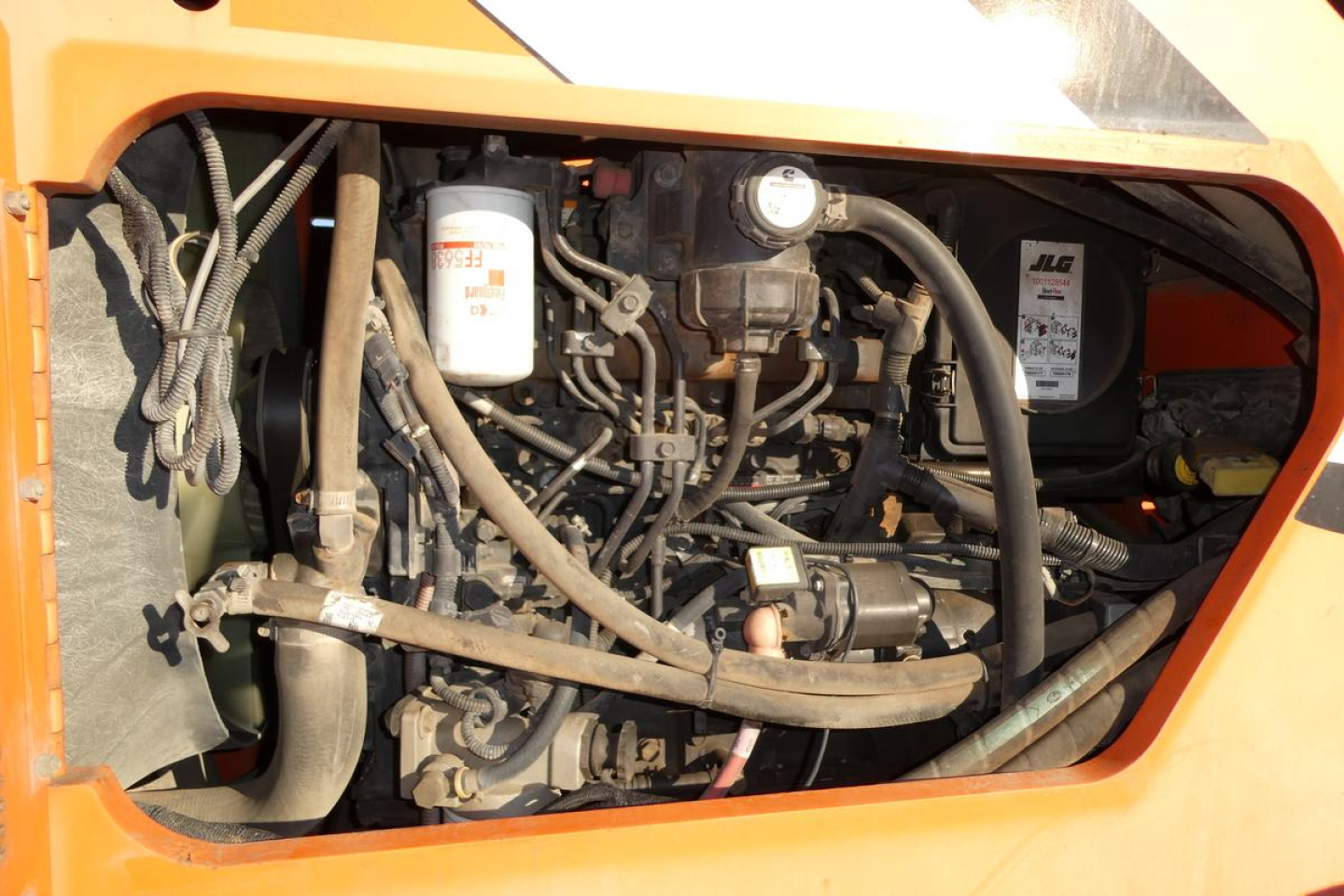 JLG 8042 engine bay showing hydraulic reservoir, hoses, and engine components.