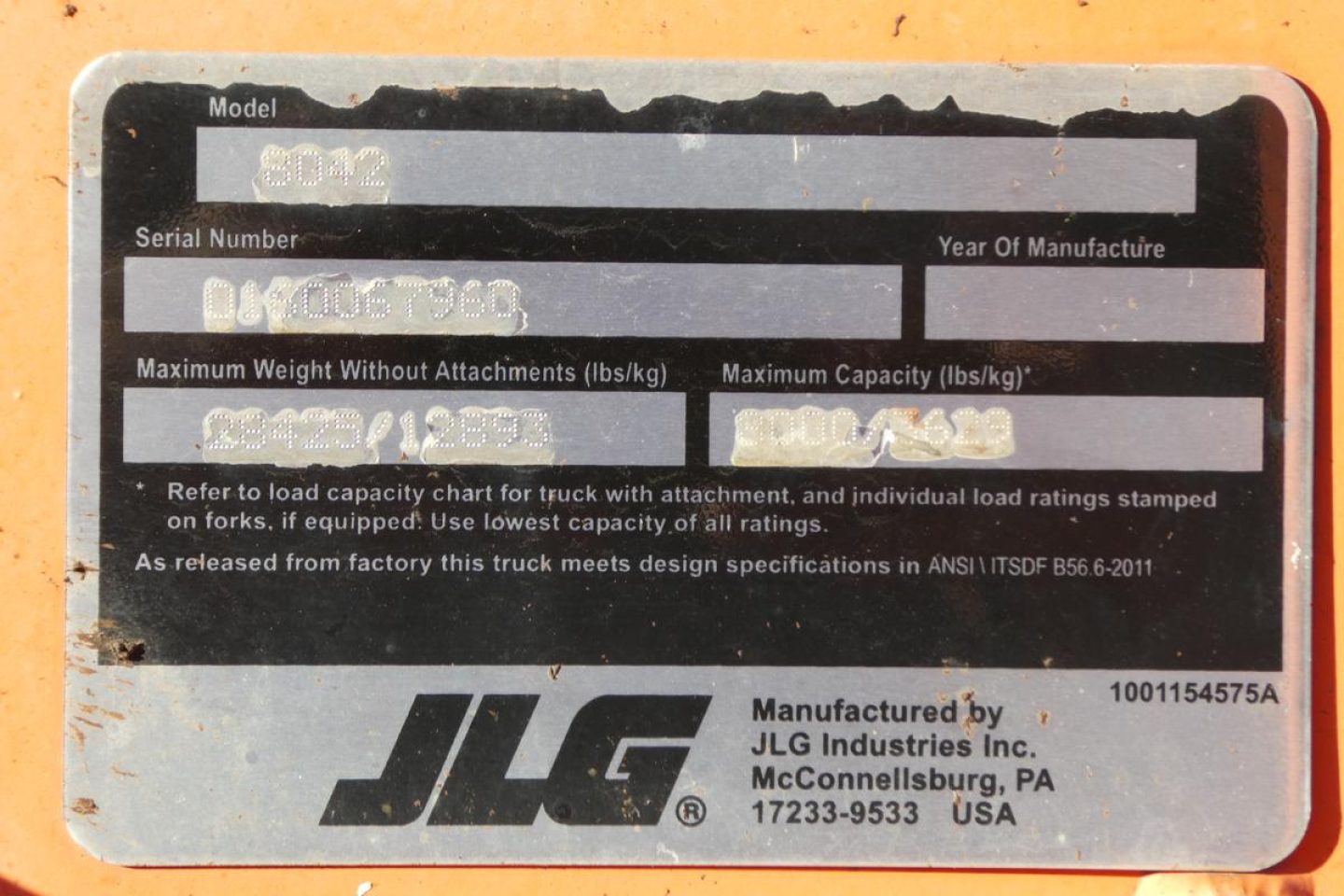 JLG 8042 machine showing the nameplate with model, serial number, and weight/capacity labels.