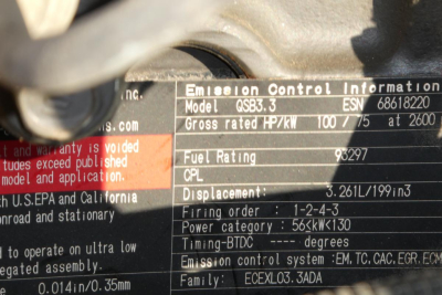 Close-up of emission control information panel on a JLG 8042 lift showing model ESN 861? and fuel rating details, with rows of text including emission information and displacements.